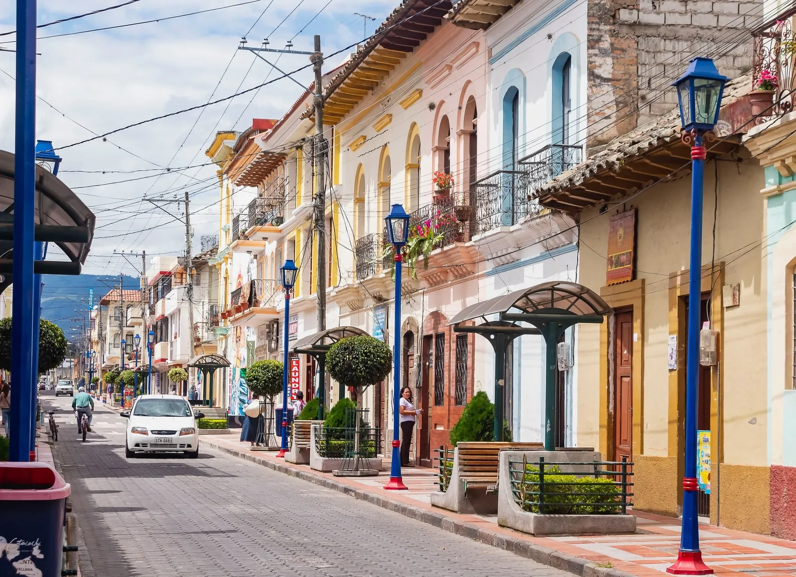 Colorful façades and everyday street life along Calle Bolívar in central Cotacachi